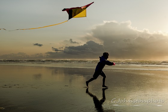 Flying a kite at the beach.