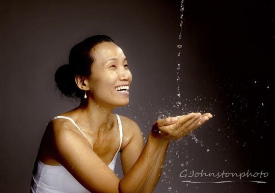 Woman enjoying a stream of water.