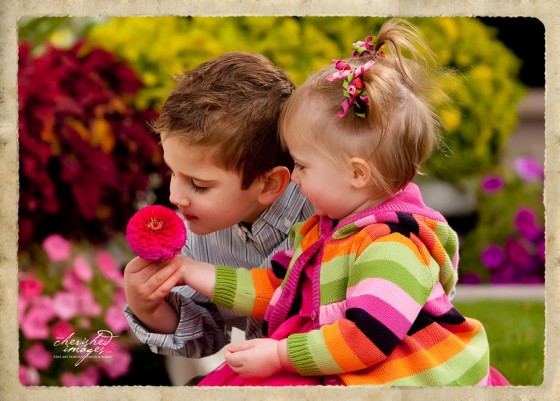 Boy and girl kids with bright colored flowers