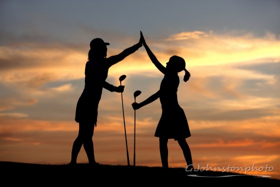 High five at sunset on the golf course.
