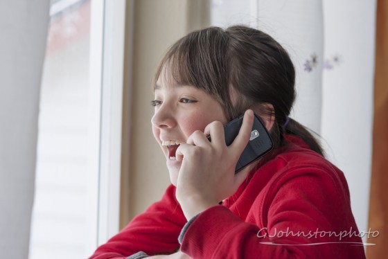 Laughing on the phone.